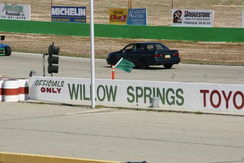 1995 Ford Taurus - A dark green 1995 Ford Taurus sedan is seen on the race track at Willow Springs.
