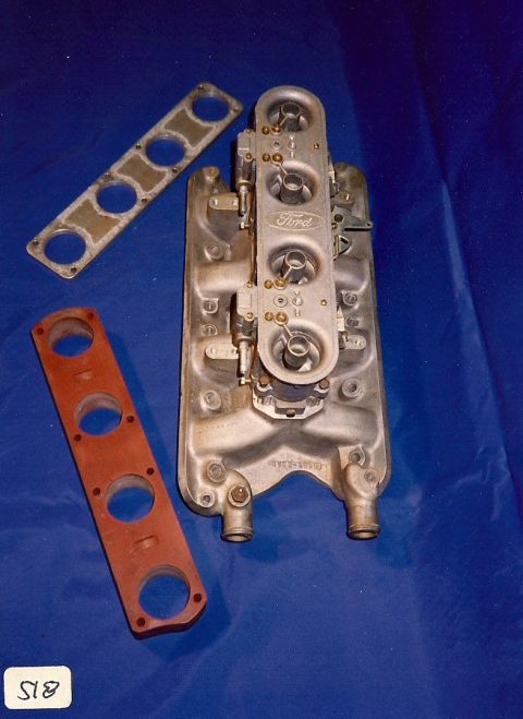 1973 Ford Mustang - A Ford intake manifold and two gaskets are laid out on a blue surface.