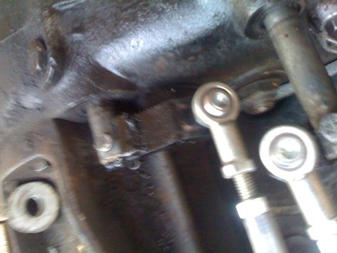 1978 Ford Bronco - This image shows a close-up view of mechanical linkage components, likely part of a vehicle's drivetrain.