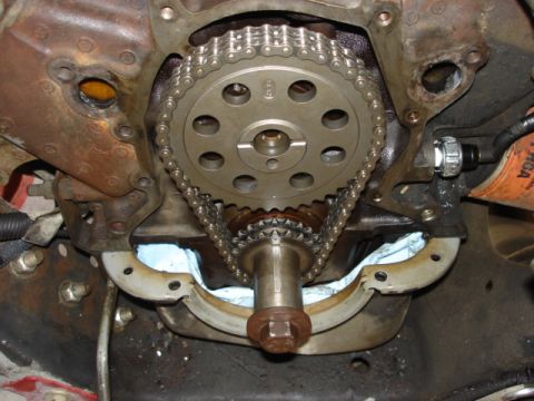 1992 Ford Bronco - Close-up view of an engine's timing chain and gears, with an oil filter and sensor in the background.