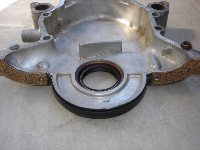 Engine part with a seal and gasket, likely a crankshaft seal housing