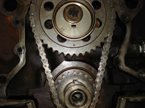 1992 Ford Bronco - Close-up view of engine timing chain and gears, with visible markings.