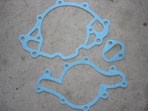1992 Ford Bronco - Set of water pump gaskets laid out on a concrete floor.