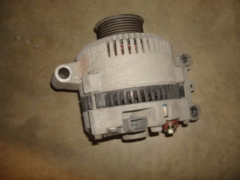 1995 Ford Bronco - A close-up view of a vehicle's alternator, a crucial component for charging the battery.