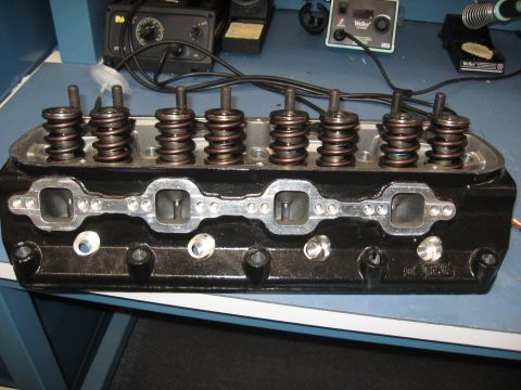 2008 Ford F-250 - A black engine cylinder head is shown with valve springs and intake ports visible.