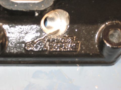 2008 Ford F-250 - Engine part with embossed text, possibly indicating torque specifications.