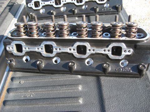 2008 Ford F-250 - Two black engine cylinder heads are shown, each with multiple valves and springs visible.