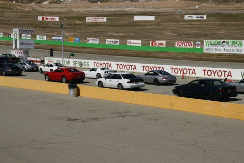 1995 Ford Taurus - Multiple vehicles are staged at the Willow Springs International Raceway.