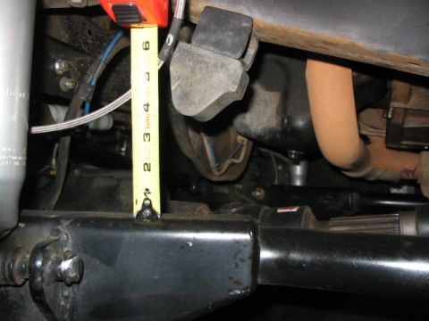 1995 Ford Bronco - A tape measure is used to show the height of suspension components on a vehicle.