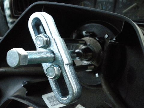 1989 Ford Bronco - A steering wheel puller tool is shown attached to a component, likely for removal or repair.