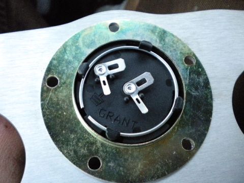 1989 Ford Bronco - Close-up of a Grant steering wheel hub adapter, showing the brand name and mounting holes.