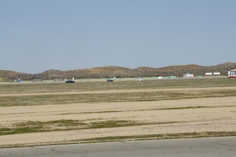 1995 Ford Taurus - Multiple vehicles are on a racetrack with a building labeled 'STR' in the background.