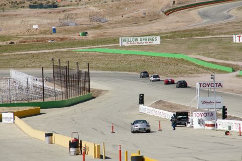 1995 Ford Taurus - Cars race on a track with 'Willow Springs' and 'Toyota' signage visible in the background.