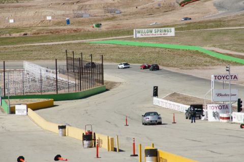 1995 Ford Taurus - Cars race on a track with grandstands and sponsor signs visible.