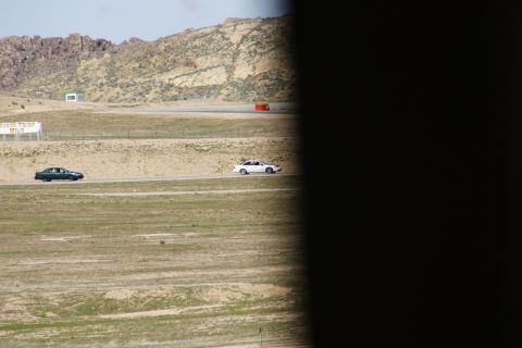 1995 Ford Taurus - Two sedans are seen on a racetrack with a sign that reads "DODGE THRIFT" in the distance.