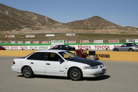 1995 Ford Taurus - White 1995 Ford Taurus with a black hood at Willow Springs Raceway.