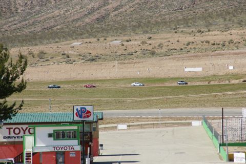 1995 Ford Taurus - Multiple vehicles are seen on a race track, with a Toyota building visible.