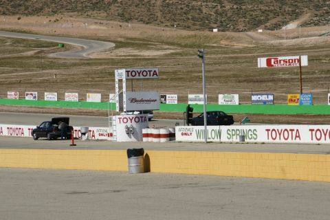 1995 Ford Taurus - A race track scene multiple vehicles and sponsor signage.