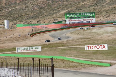 1995 Ford Taurus - Cars race on the track at Willow Springs International Raceway, with a Toyota advertisement visible.