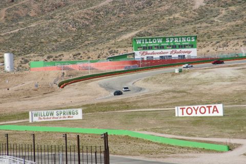 1995 Ford Taurus - Cars race on the track at Willow Springs International Raceway, with prominent signage for Willow Springs and Toyota.