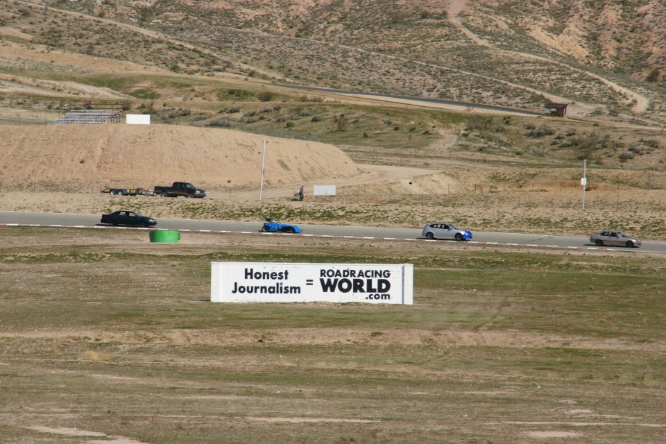 Cars on a race track with a sign that says Honest Journalism = ROADRACING WORLD.com