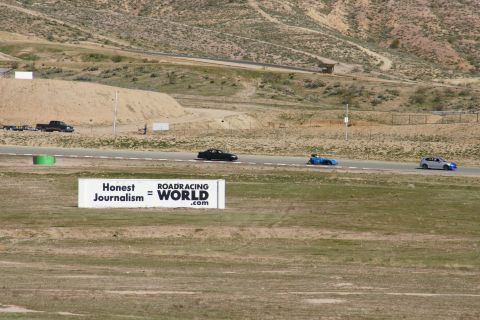 1995 Ford Taurus - Cars race on a track with a billboard in the foreground.