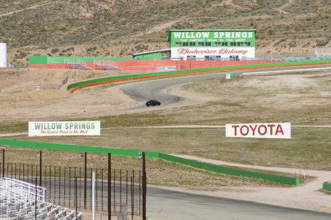1995 Ford Taurus - A lone car navigates the curves at Willow Springs International Raceway.