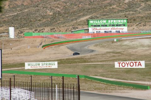 1995 Ford Taurus - A lone car navigates the Willow Springs International Raceway circuit.