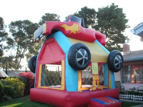1991 Ford Bronco - This inflatable bounce house is designed to resemble a race car, complete with flames and large wheels.