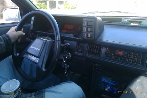 2000 Mercury Grand Marquis - Interior view of a car, a steering wheel and dashboard with various controls and digital readouts.