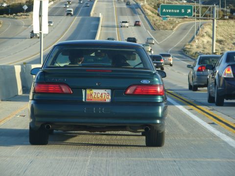 1992 Ford Taurus - A 1992 Ford Taurus sedan is seen from behind on a multi-lane highway.