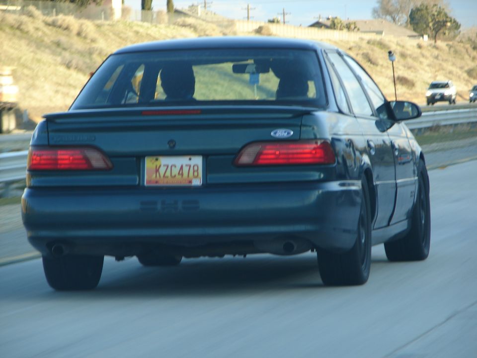 1992 Ford Taurus rear view, dark green sedan with license plate KZC478
