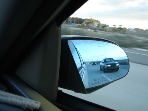 1992 Ford Taurus - View from car interior shows another car in the side mirror with construction in the distance.