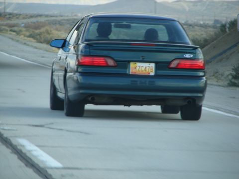 1992 Ford Taurus - This 1992 Ford Taurus is seen from the rear on a highway, with a license plate visible.