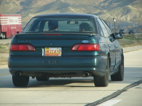 1992 Ford Taurus - Rear view of a 1992 Ford Taurus driving on the highway.