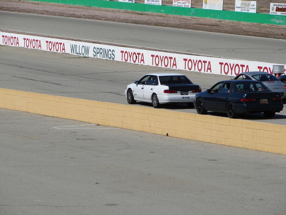 1992 Ford Taurus, white with black trunk, on race track