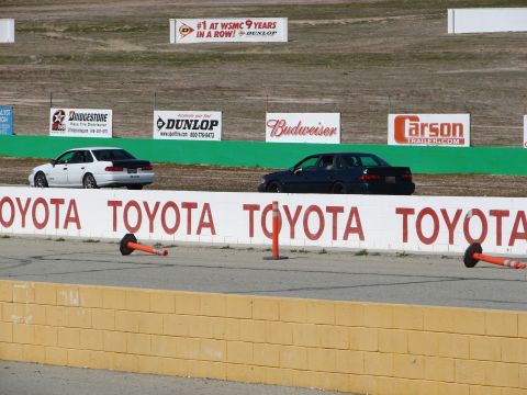 1992 Ford Taurus - Cars race on a track with "TOYOTA" branding on the wall and various sponsor banners in the background.