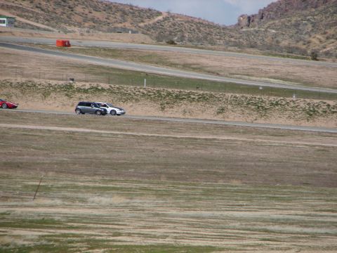 1992 Ford Taurus - Two cars are seen on a race track during a sunny day.