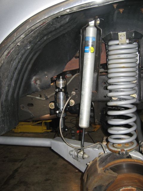 1996 Ford Bronco - This image shows the suspension system of a vehicle, including a shock absorber and coil spring.