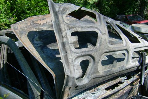1981 Toyota Hilux - A heavily damaged and burnt vehicle part is visible, with another vehicle in the background.