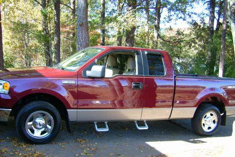 1981 Toyota Hilux - This maroon Ford F-150 pickup truck features tan lower body panels and side steps.