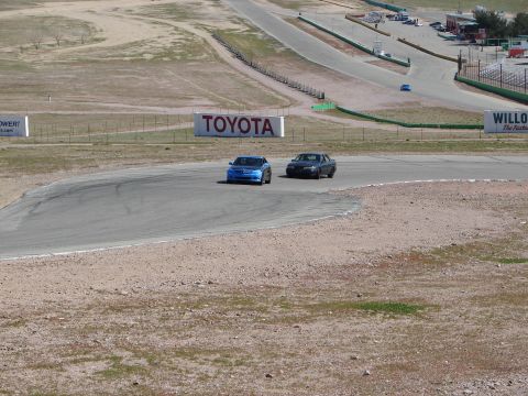 1992 Ford Taurus - Two sedans race on a track with a Toyota billboard visible.