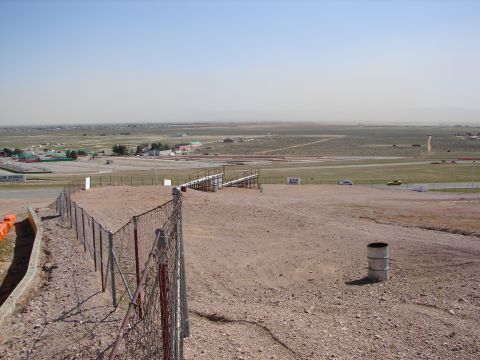 1992 Ford Taurus - A wide view of a race track facility on a clear day, with a chain-link fence in the foreground.
