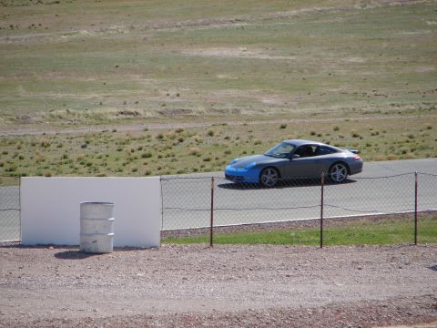 1992 Ford Taurus - A Porsche 911 is seen on a racetrack with a blue front bumper.