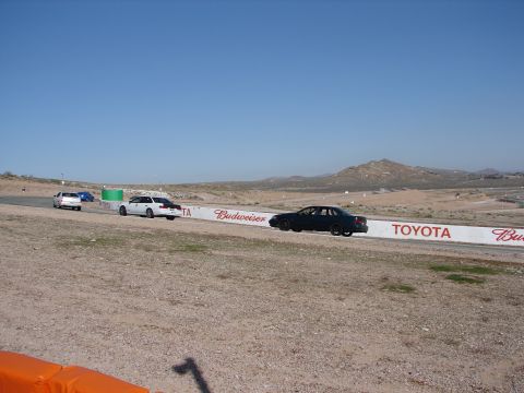 1992 Ford Taurus - Cars race on a track with sponsor banners visible along the side.