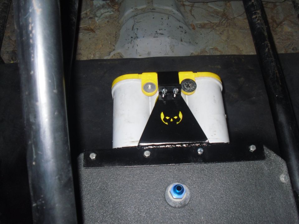 Dual batteries with yellow caps and a black bracket a yellow skull logo