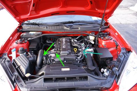 2010 Hyundai Genesis - The engine bay of a 2010 Hyundai Genesis is shown with arrows highlighting the intake system.
