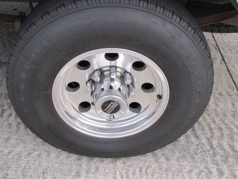 1993 Ford F-250 - Close-up of a truck wheel and tire assembly, showing aftermarket alloy wheels and a steeltex tire.