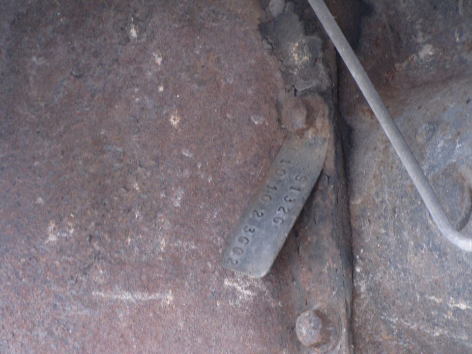 Stamped metal tag with numbers S1326 10 10 2 3002
