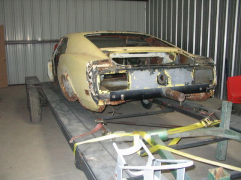 1970 Ford Mustang - This 1970 Ford Mustang is seen on a trailer, showing significant rust and damage to its rear end.